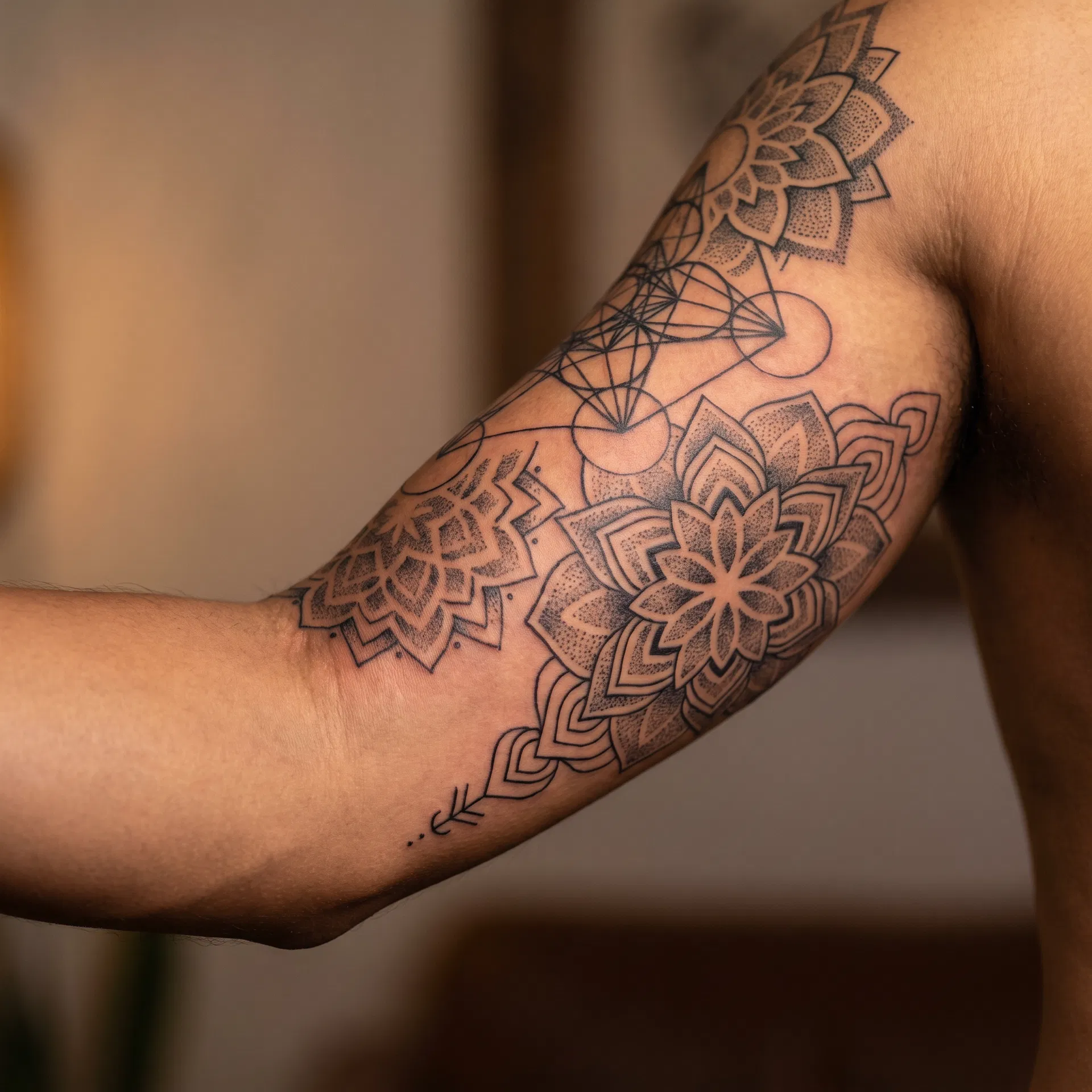 Geometric mandala tattoo on arm